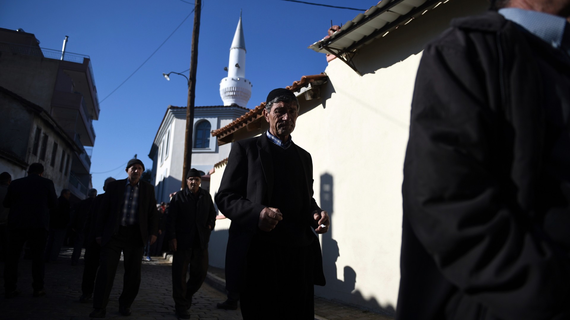 Pilgrims wait to enter at Kirmahalle Cammi mosque in the northeastern Greek town of Komotini, in 2017 (AP)