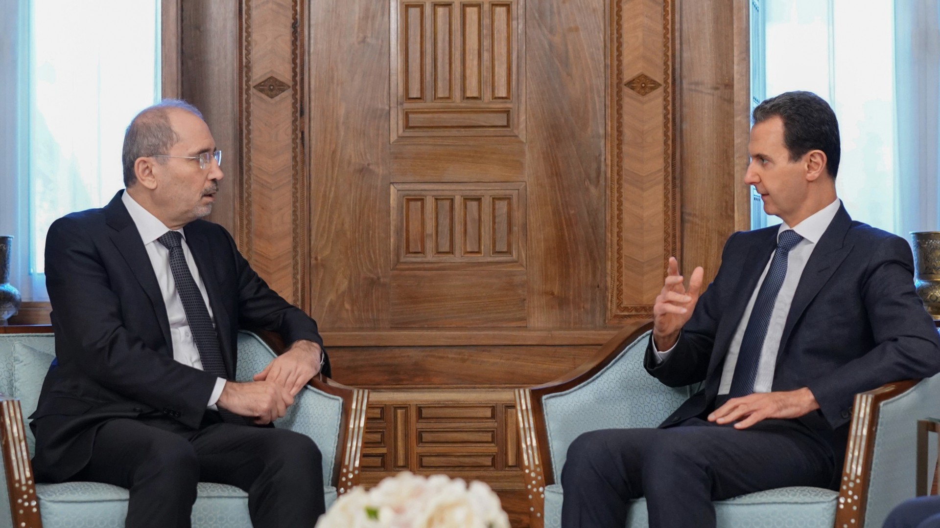 Syrian President Bashar Assad, right, meets Jordanian Foreign Minister Ayman Safadi in Damascus, 15 February (AP)