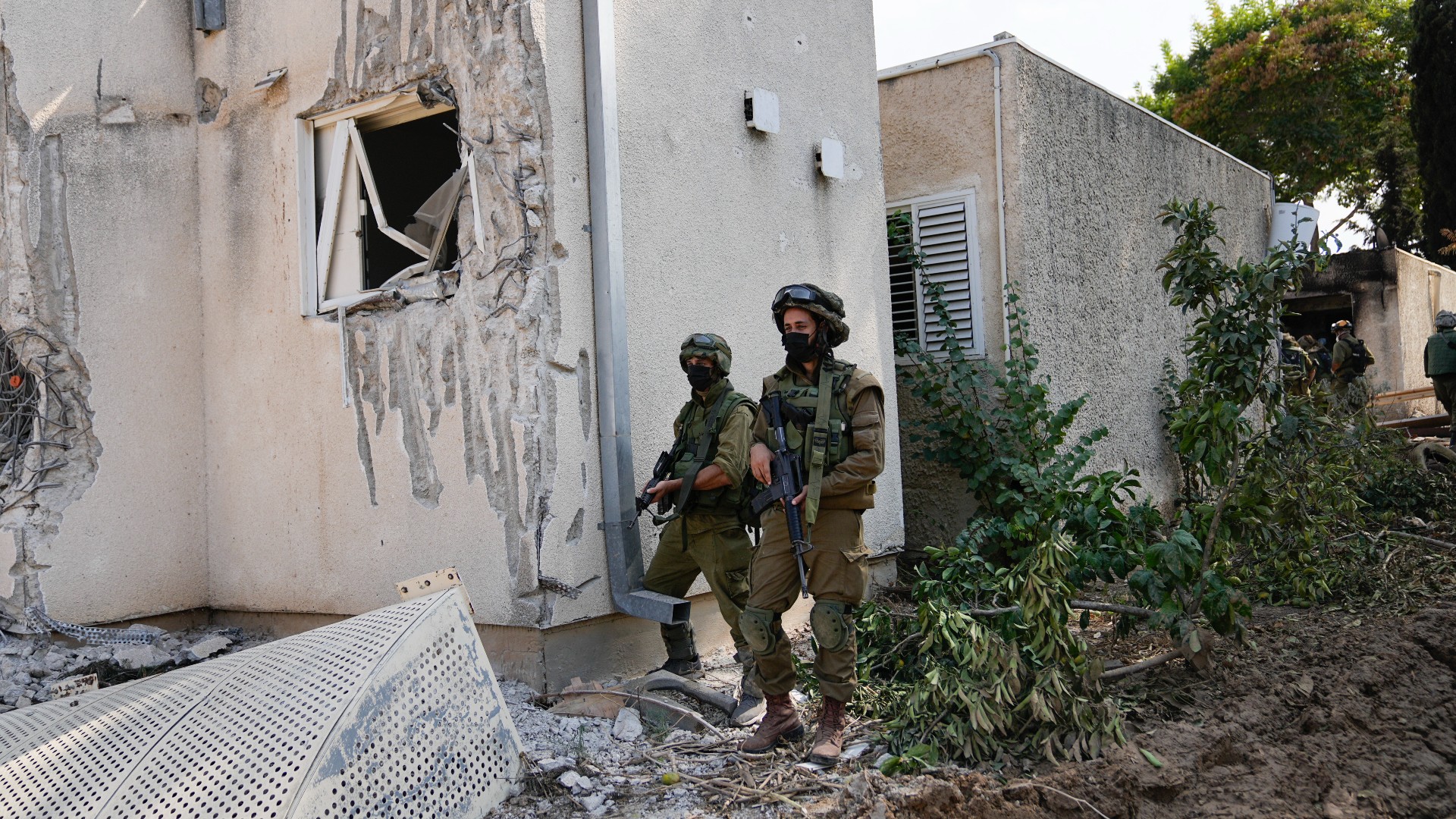 Israeli soldiers stand guard in kibbutz Kfar Azza on 10 October (AP)