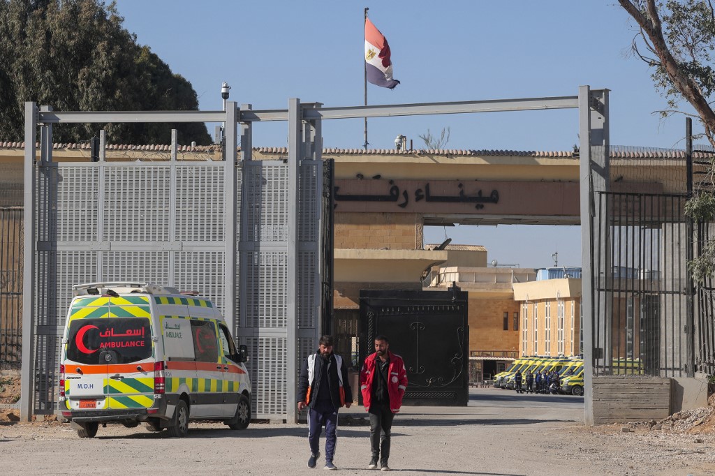An ambulance parked on the Palestinian side of the Rafah crossing with Egypt as paramedics wait for wounded evacuees to cross, 17 February 2024 (Said Khatib/AFP)