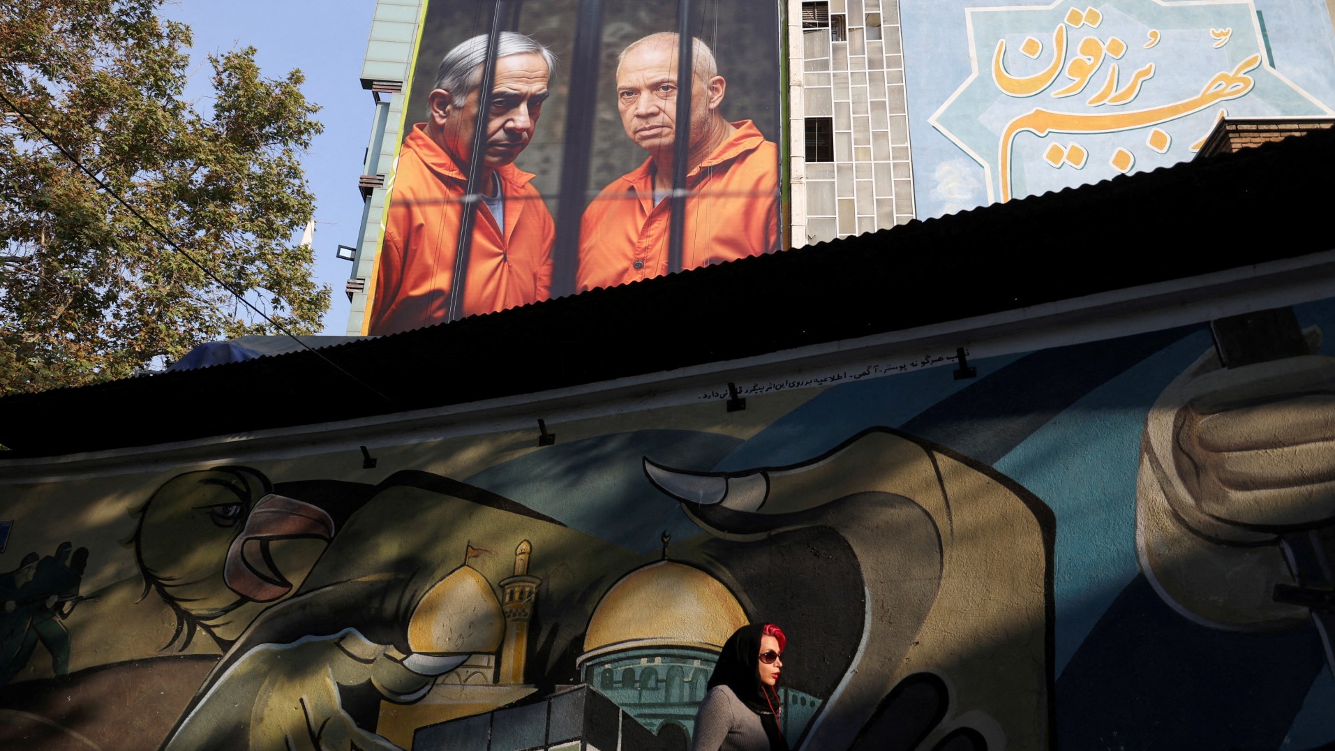 An anti-Israeli billboard with a picture of Israel's Prime Minister Benjamin Netanyahu and Former Israeli Defense Minister Yoav Gallant is displayed on a building in Tehran, Iran November 24, 2024