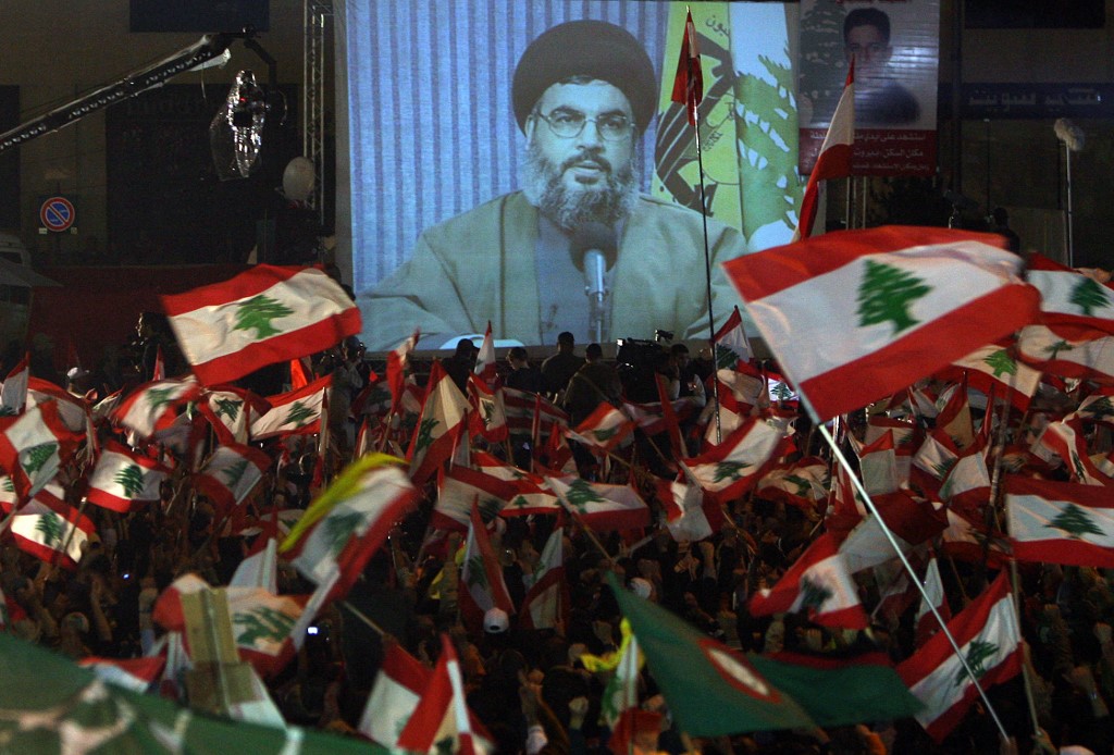 Hezbollah secretary general Hassan Nasrallah addresses supporters through a broadcasted speech on a giant screen in downtown Beirut 07 December 2006 (AFP)