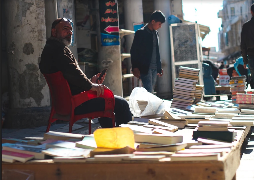 Books stacked high at the historic Friday book market (MEE/Pesha Magid)