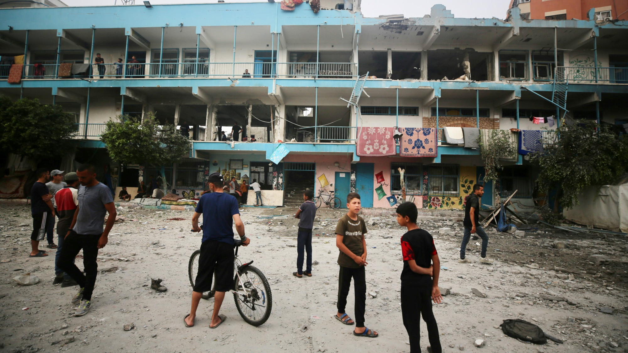 Palestinians inspect a UN school housing displaced people that was hit by Israeli bombardment in Nuseirat, in the central Gaza Strip, on 6 June 2024 (MEE/Mohammed al-Hajjar)