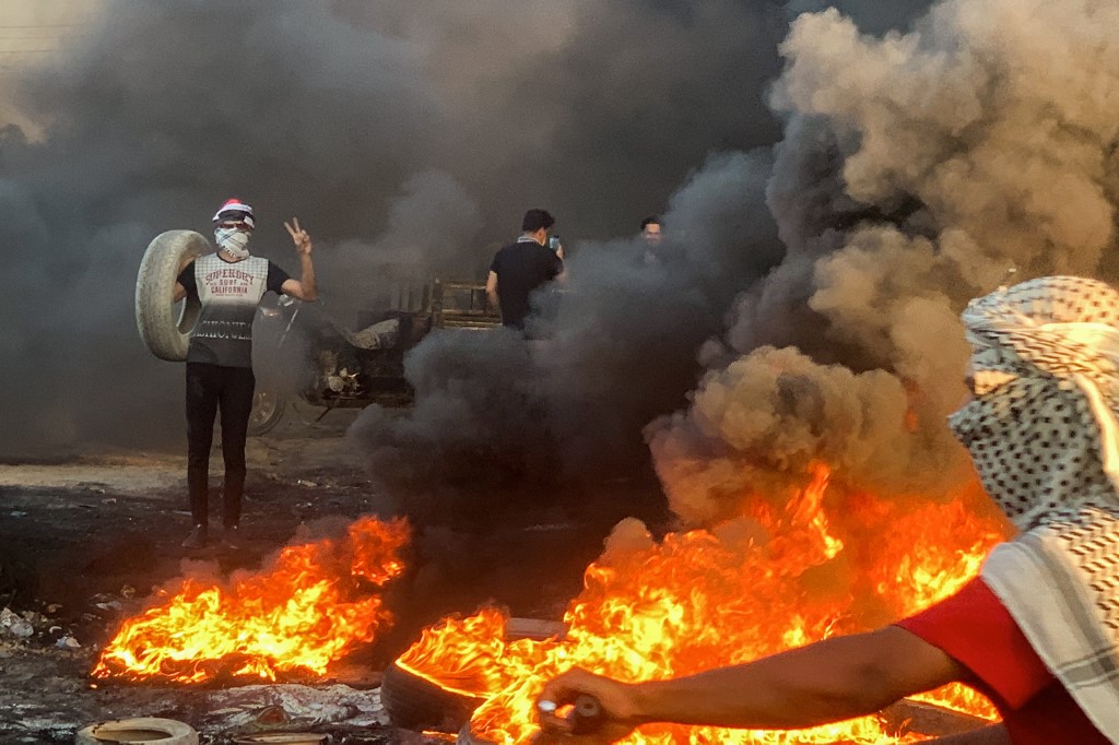 On July 13, 2024, demonstrators burning tyres to block a road as they rally to protest the deterioration of daily electricity supply on a road in the Ghammas district (Haidar Indhar / AFP)