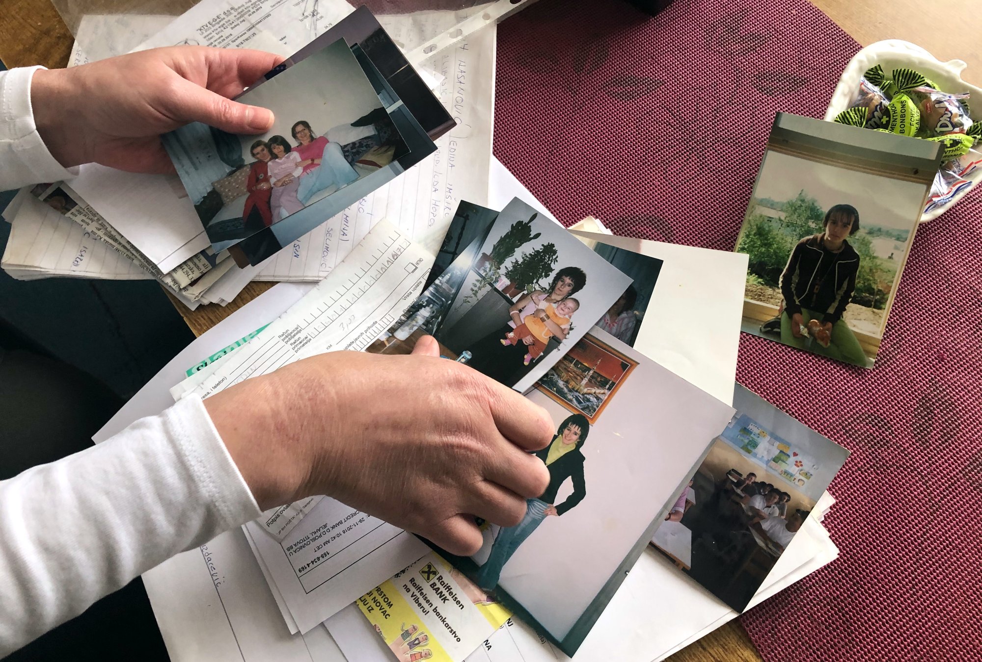 Alema Dolamic shows old photos of her sister Adela before she left for Syria (MEE/Elvira Jukic-Mujkic)