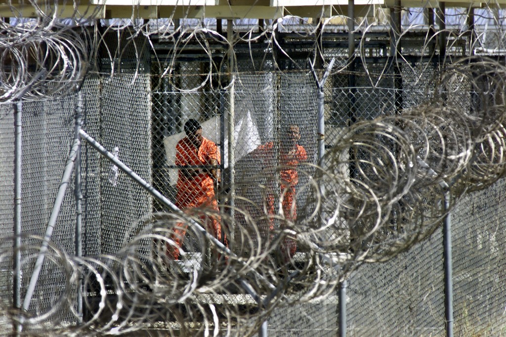 Detainees wash before midday prayers at Guantanamo Bay prison, 27 January 2002