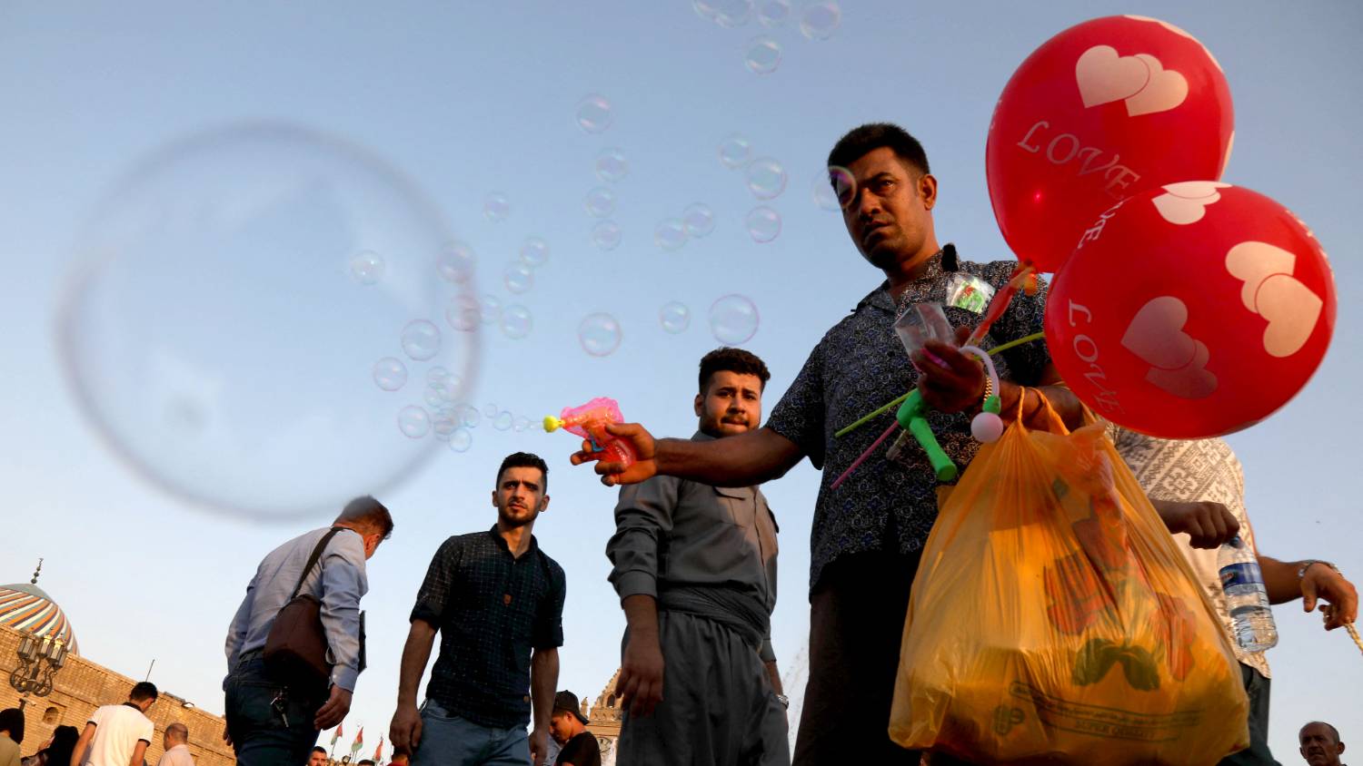This man sells balloons and bubble blowers to children celebrating Eid in Irbil [Safin Hamed/AFP]