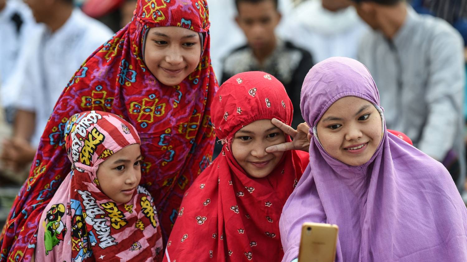 A group of young girls gather to enjoy Eid celebrations in Indonesia (Mohammed Rasfan AFP)