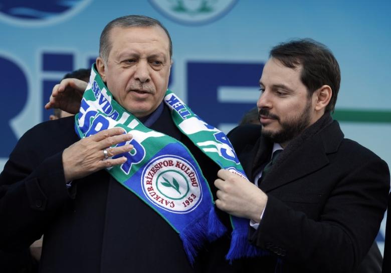 Erdogan receives a scarf of Caykur Rizespor from Albayrak during a rally for the presidential referendum in the Black Sea city of Rize inn 2017 (Reuters)