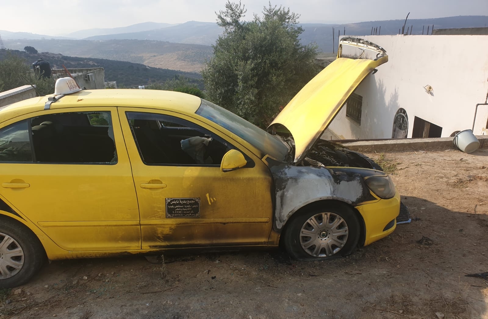 One of the two vehicles damaged by the arson attack in Faraata on 4 August 2020 (Supplied)