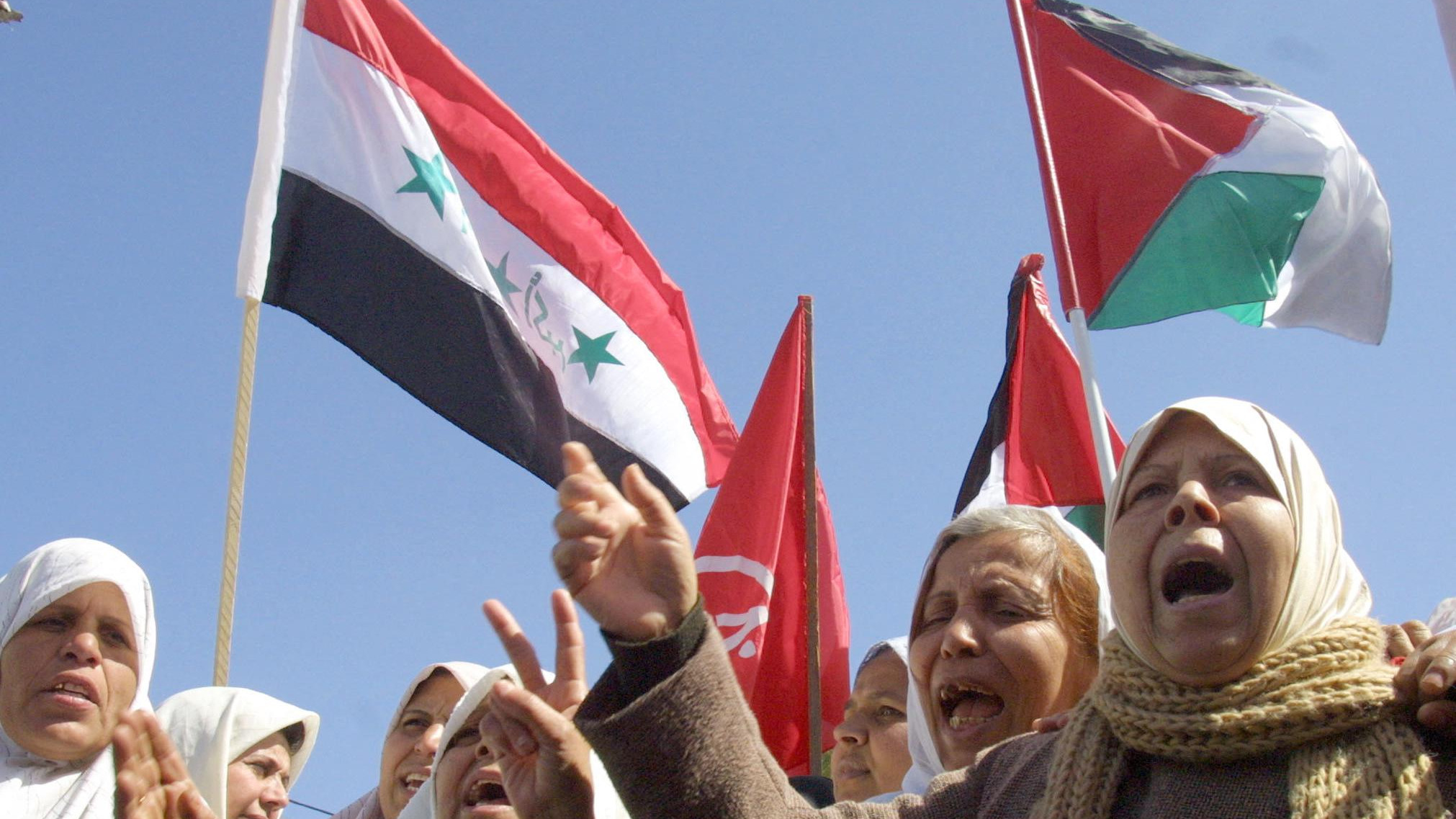 Palestinian women shout slogans against the US and Israel during a demonstration against the planned US invasion of Iraq in Gaza City on 1 March 2003 (Mohammed Saber/AFP). 