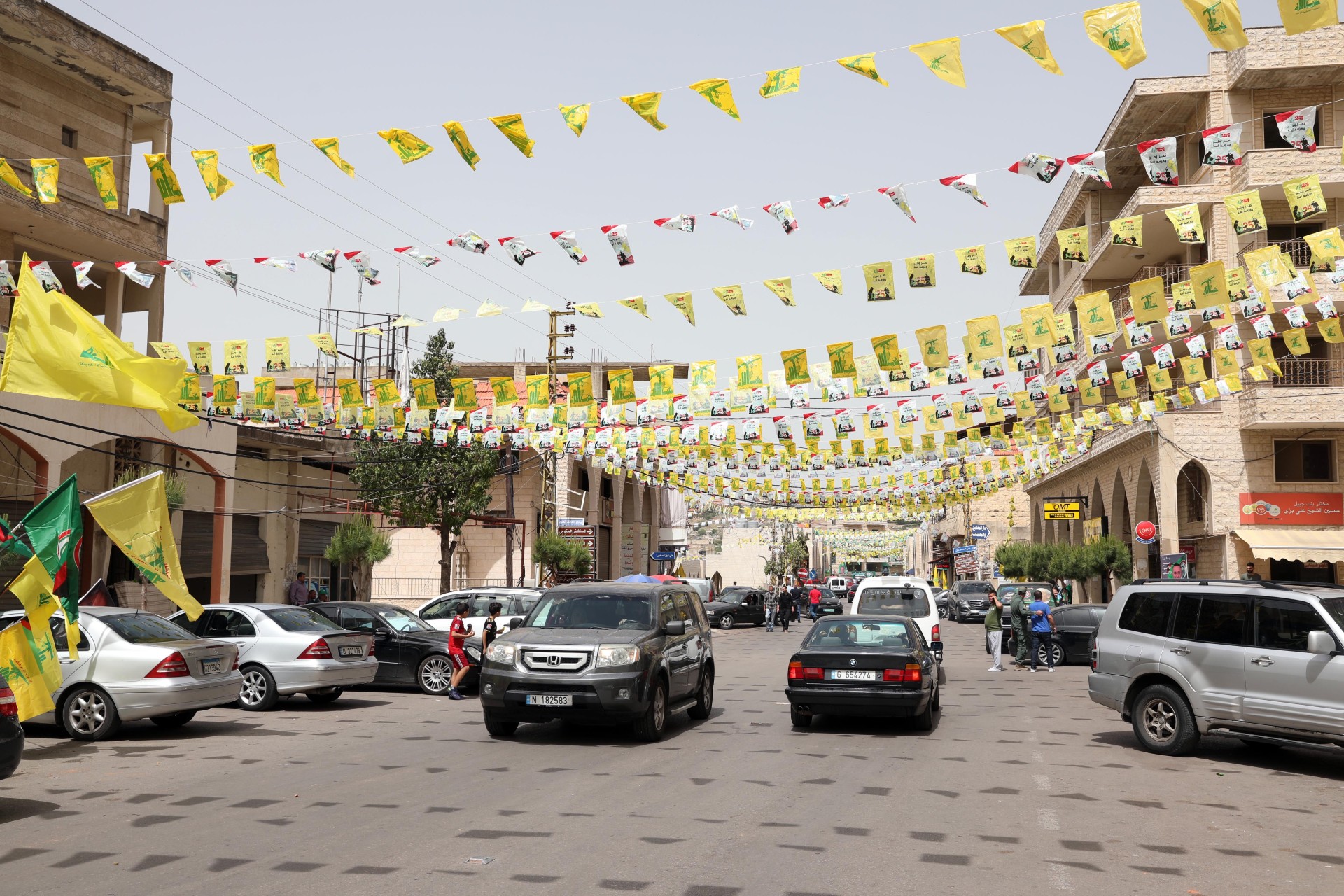 Hezbollah flags are seen strung across the road in Bint Jbeil (MEE/Hassan Shaaban)