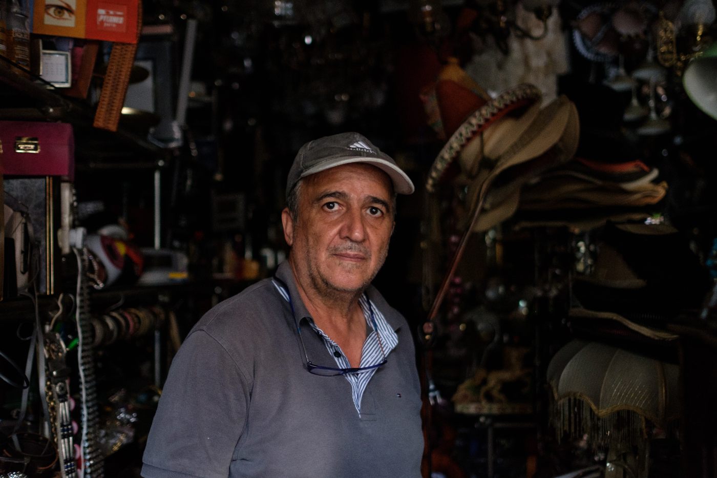 Ghassan Houry, the owner of Hamra Vintage store, now asks his customers to use their phone flashlights to look at the wares inside his shop (MEE/Rita Kabalan)