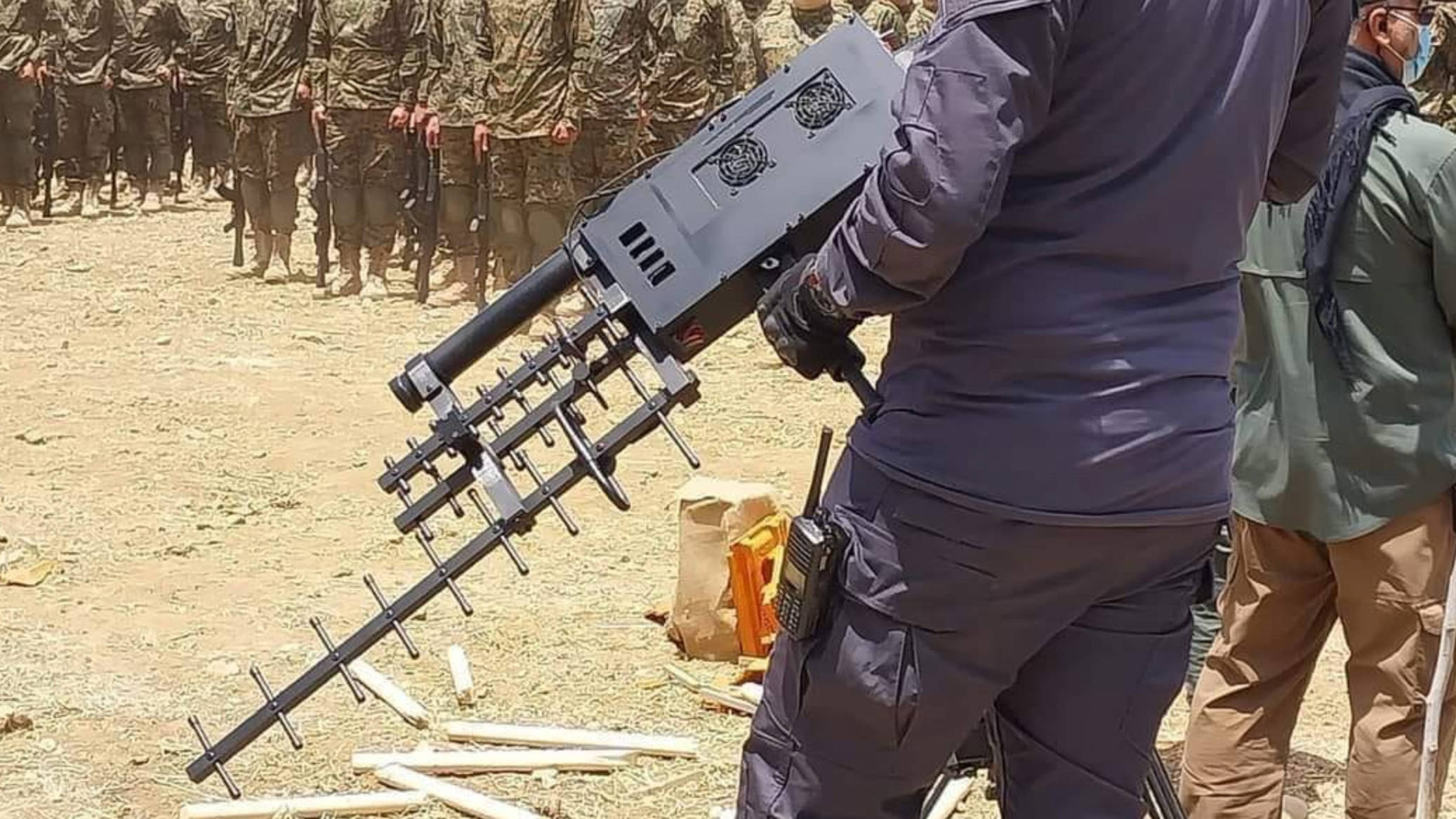 A Hezbollah fighter holds one of two anti-drone guns unveiled at the military show (Manar)