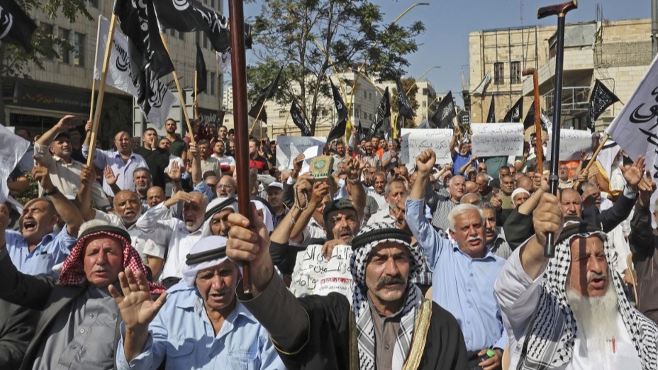 Supporters of Hizb ut-Tahrir or the Islamic Liberation Party of the Islamic Liberation Party march demanding a ban on Jewish prayer at Al-Aqsa mosque in the West Bank town of Hebron, on October 09, 2021