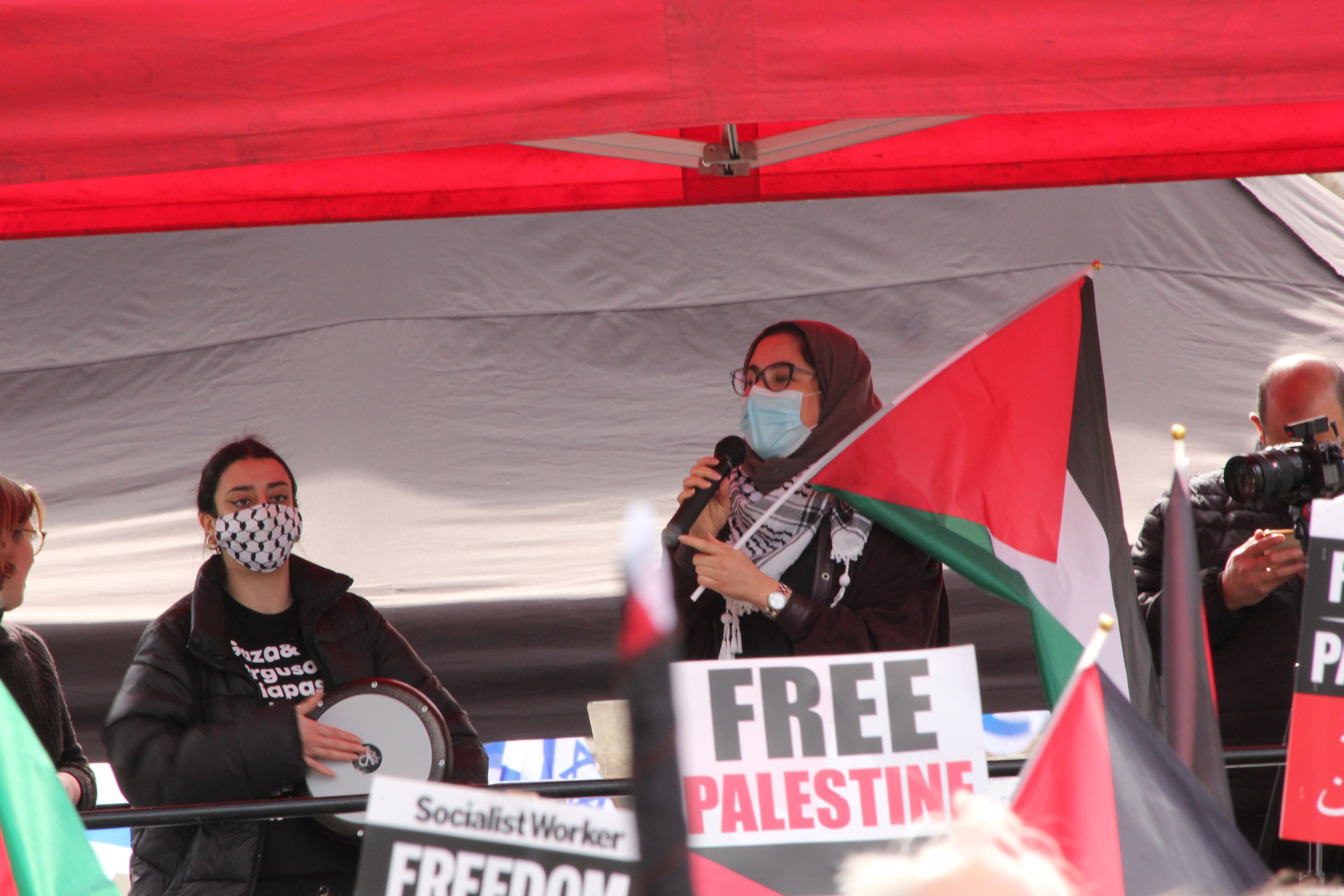 Pro-Palestinian campaigners speak on a platform outside Whitehall (MEE/Alex MacDonald)