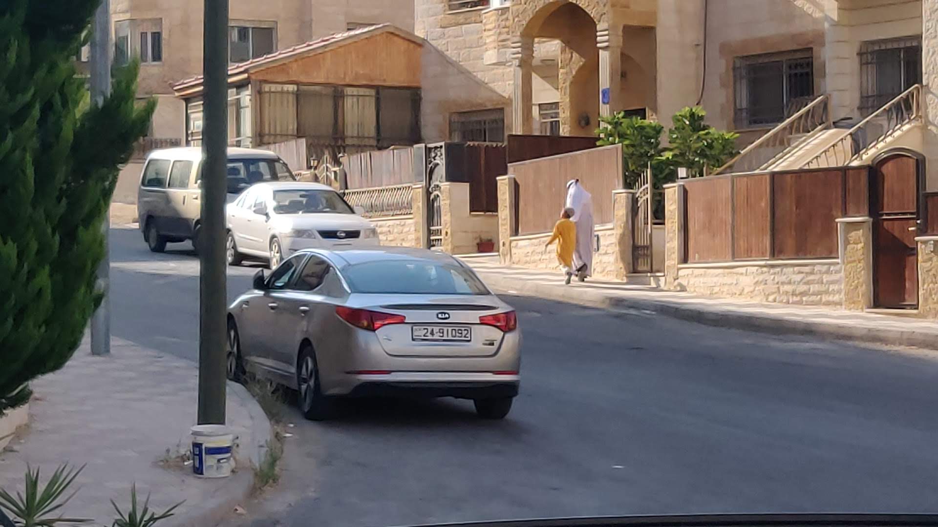 A female follower of Nuh Ha Mim Keller walking their child in Hayy al Kharabjah (MEE) 