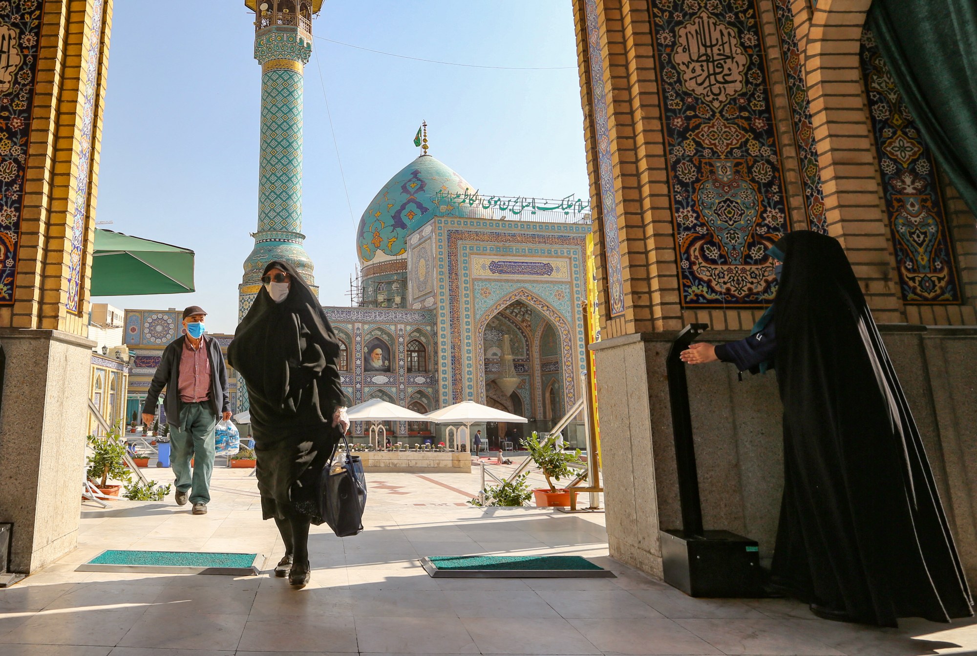 Mask-clad Iranians visit the Imamzadeh Saleh mosque in the capital Tehran on 1 November 2020 (AFP)