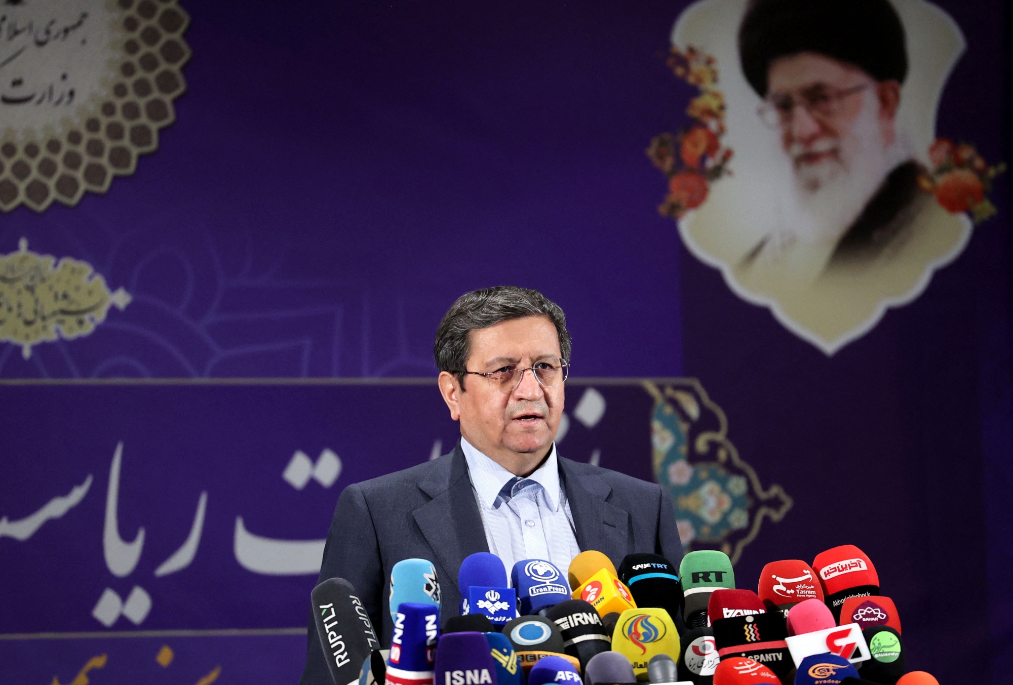 Abdolnasser Hemmati talks to journalists after registering his candidacy for the June presidential elections at the Interior Ministry in the capital Tehran, on 15 May 2021 (AFP)