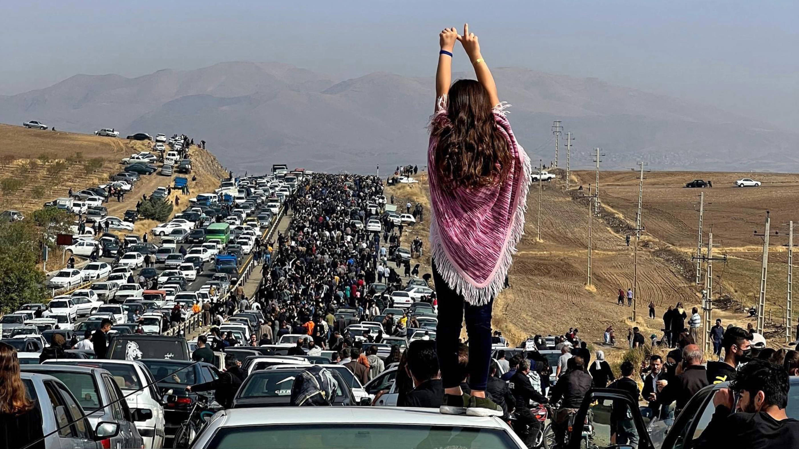 This UGC image posted on Twitter reportedly on 26 October 2022 shows thousands of people make their way towards Aichi cemetery in Saqez, Mahsa Amini's hometown, to mark 40 days since her death (AFP/UGC image)