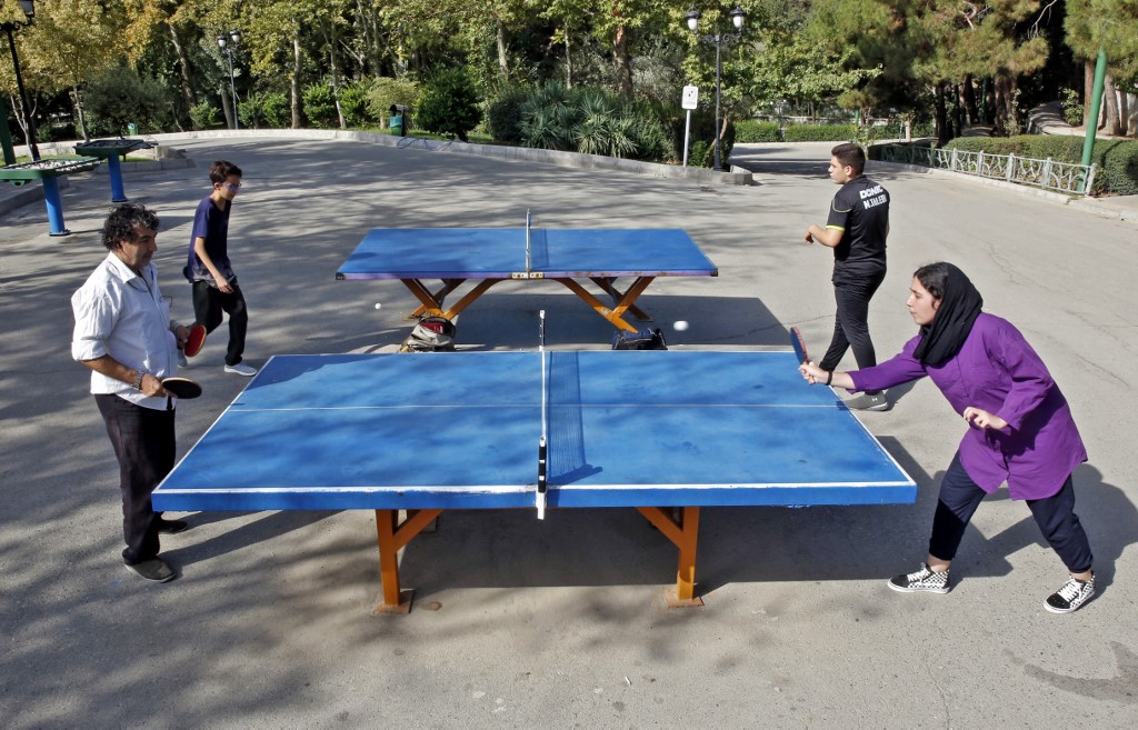Iranians play table tennis in a Tehran park, 10 September 2021 (AFP)