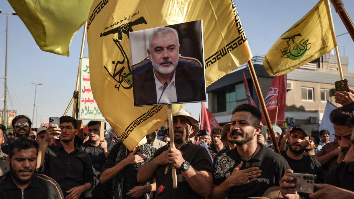 Supporters of Iraq's Hashed al-Shaabi hold picture of slain political leader of Hamas, Ismail Haniyeh, during march in Baghdad to condemn his assassination, on 31 July 2024 (Ahmad al-Rubaye/AFP)Supporters of Iraq's Hashed al-Shaabi hold picture of slain political leader of Hamas, Ismail Haniyeh, during march in Baghdad to condemn his assassination, on 31 July 2024 (Ahmad al-Rubaye/AFP)