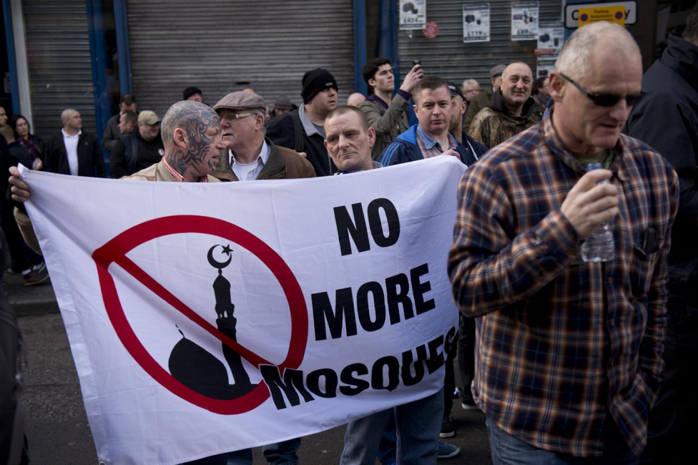 Protesters hold a banner reading 'No more mosque' during a demonstration by the UK branch of the German group 'Pegida' in the city centre of Newcastle upon Tyne, on 28 February, 2015 (AFP)