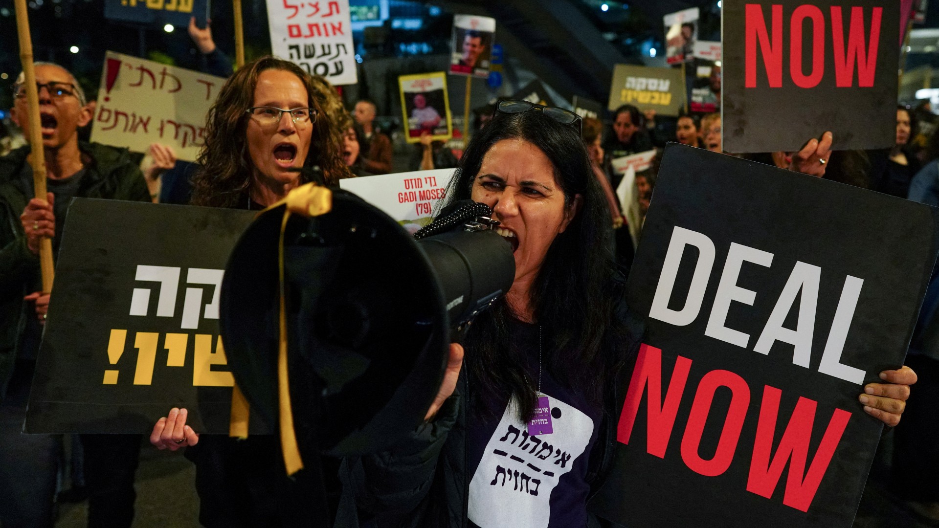Families of captives and supporters block a road as they shout slogans during a protest in Tel Aviv, 18 January (Reuters/Alexandre Meneghini)