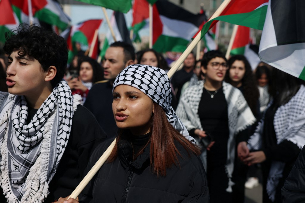 Protesters wave Palestinian flags during a demonstration marking the annual Land Day in the northern Arab-Israeli town of Sakhnin on 30 March 2023 (Ahmad Gharabli/AFP)