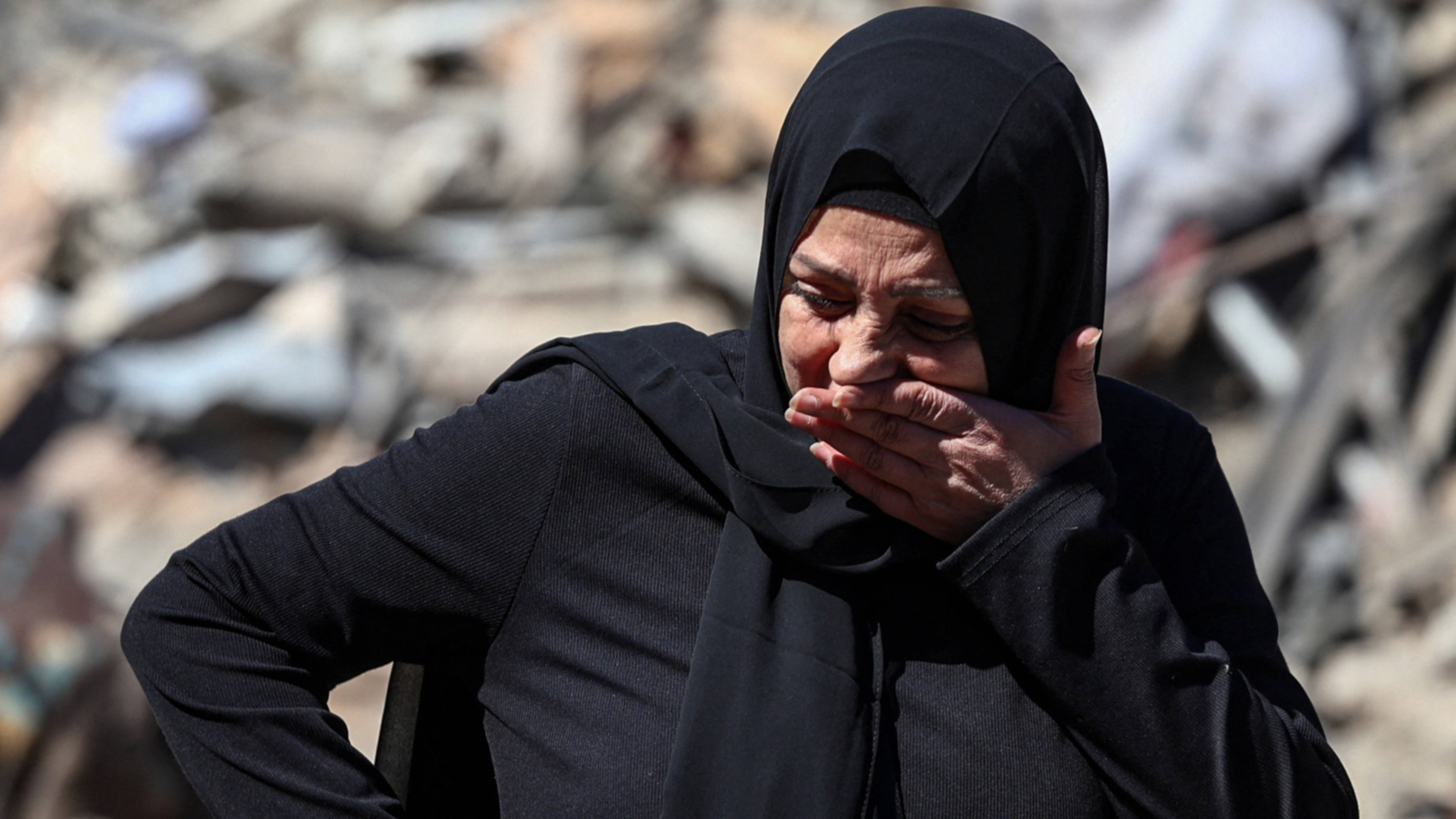 A distressed woman reacts at the site of an Israeli strike near the Rafik Hariri University Hospital in Beirut, 22 October 2024 (Reuters)