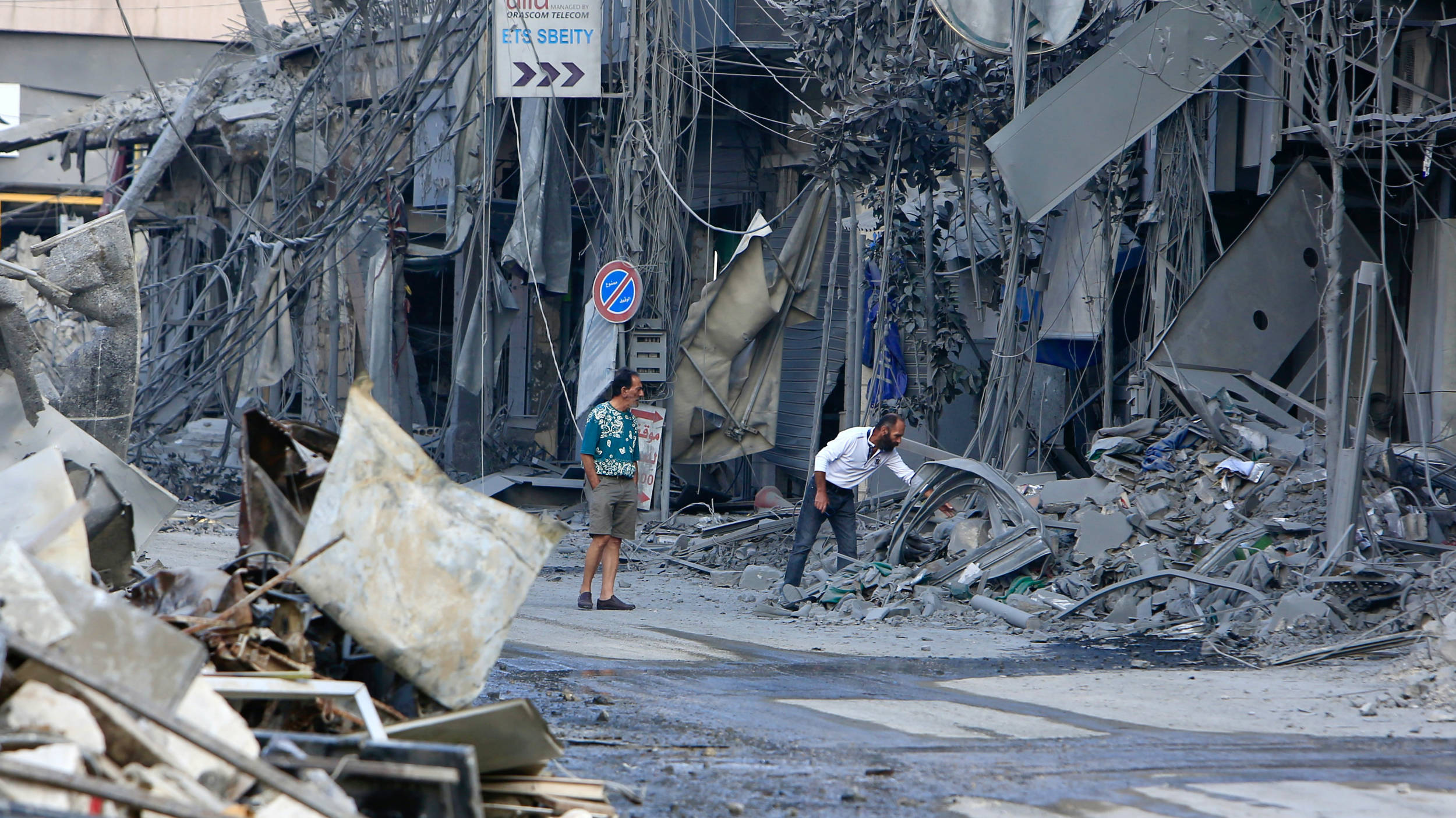 People check the destruction a day after Israeli air strikes that targeted the southern Lebanese city of Nabatieh on 17 October 2024 (AFP)