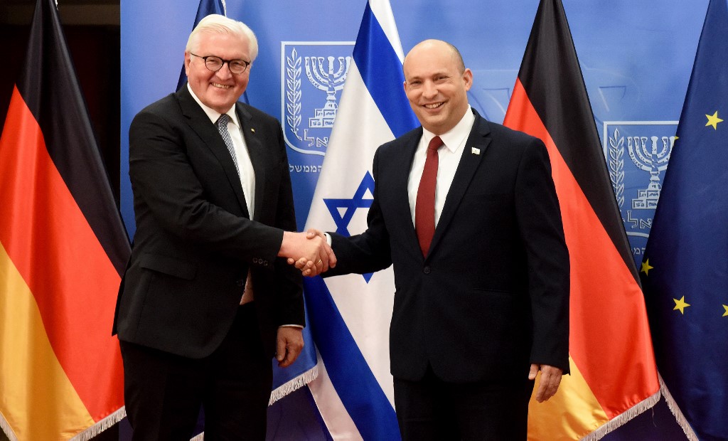 Israeli Prime Minister Naftali Bennett (R) greets German President Frank-Walter Steinmeier at his office in Jerusalem, on 1 July 2021 (AFP)
