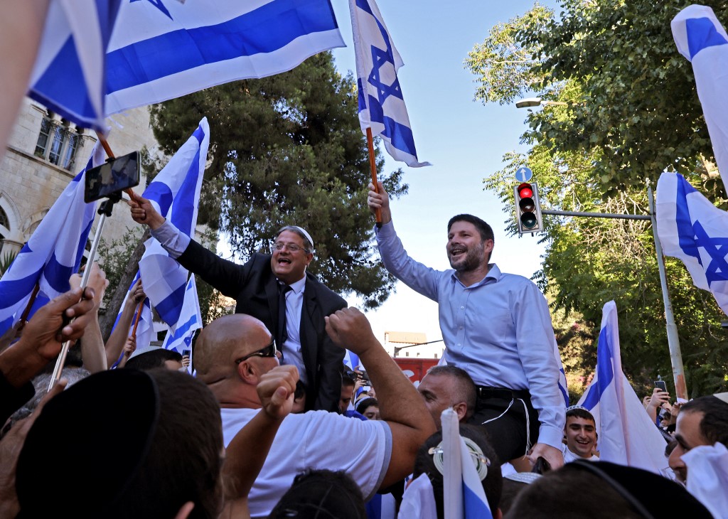 Israeli far-right lawmakers Bezalel Smotrich (R) and Itamar Ben-Gvir take part in the ultranationalist March of the Flags near Jerusalem's Old City, 15 June 2021 