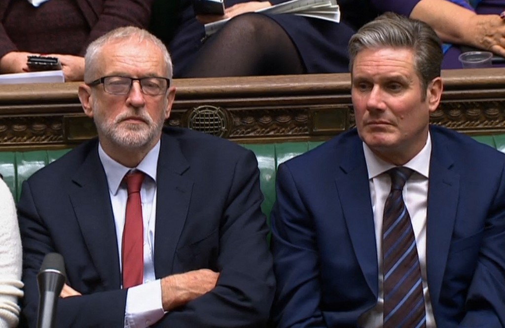 The Labour leader Jeremy Corbyn (L) and Keir Starmer, then shadow Brexit secretary, listening to a debate in the House of Commons, London, 21 October 2019 (AFP)