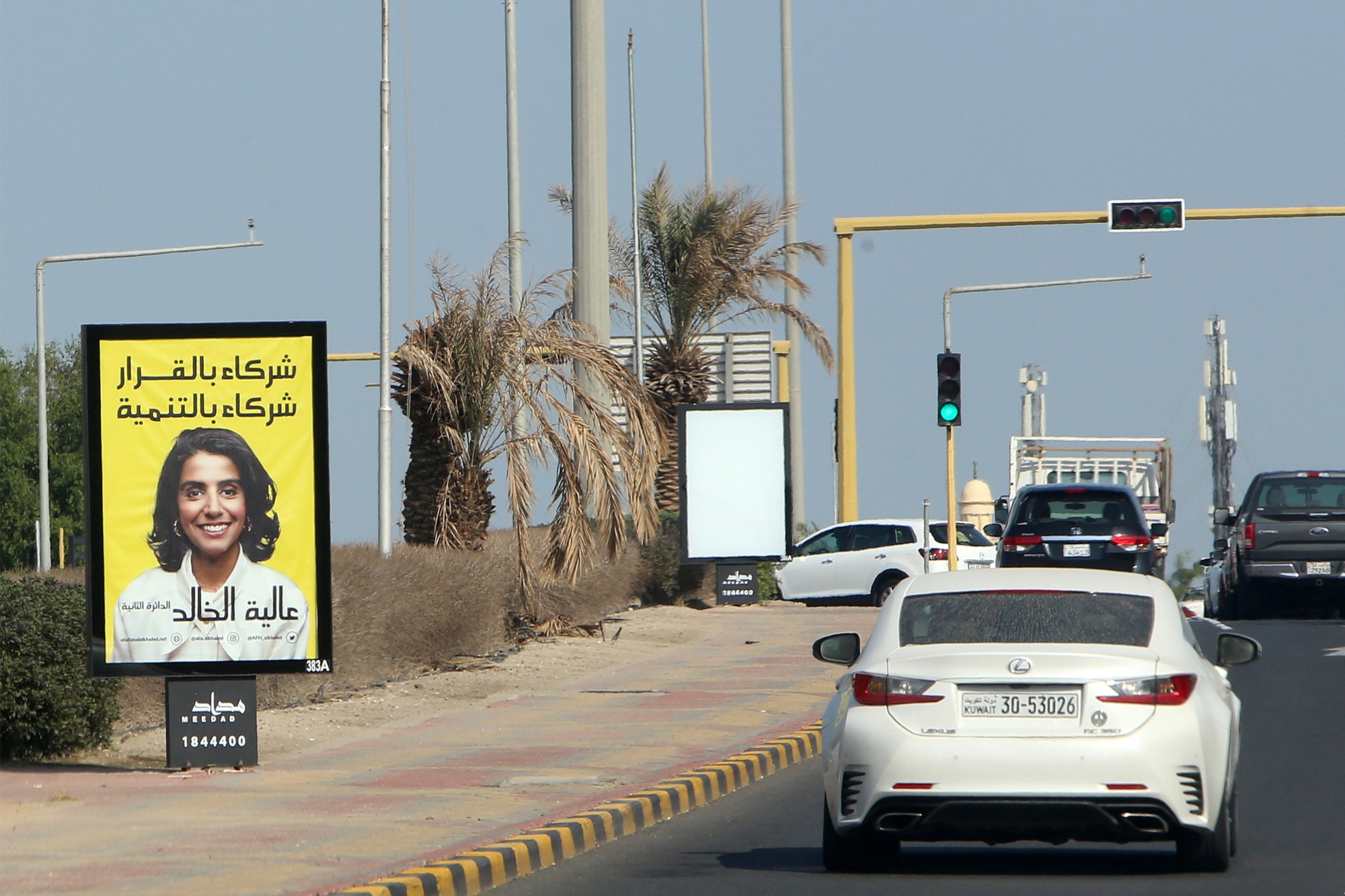 A billboard featuring a candidate running for Kuwait's parliamentary elections is seen in Kuwait city, on 22 November 2020 (AFP)