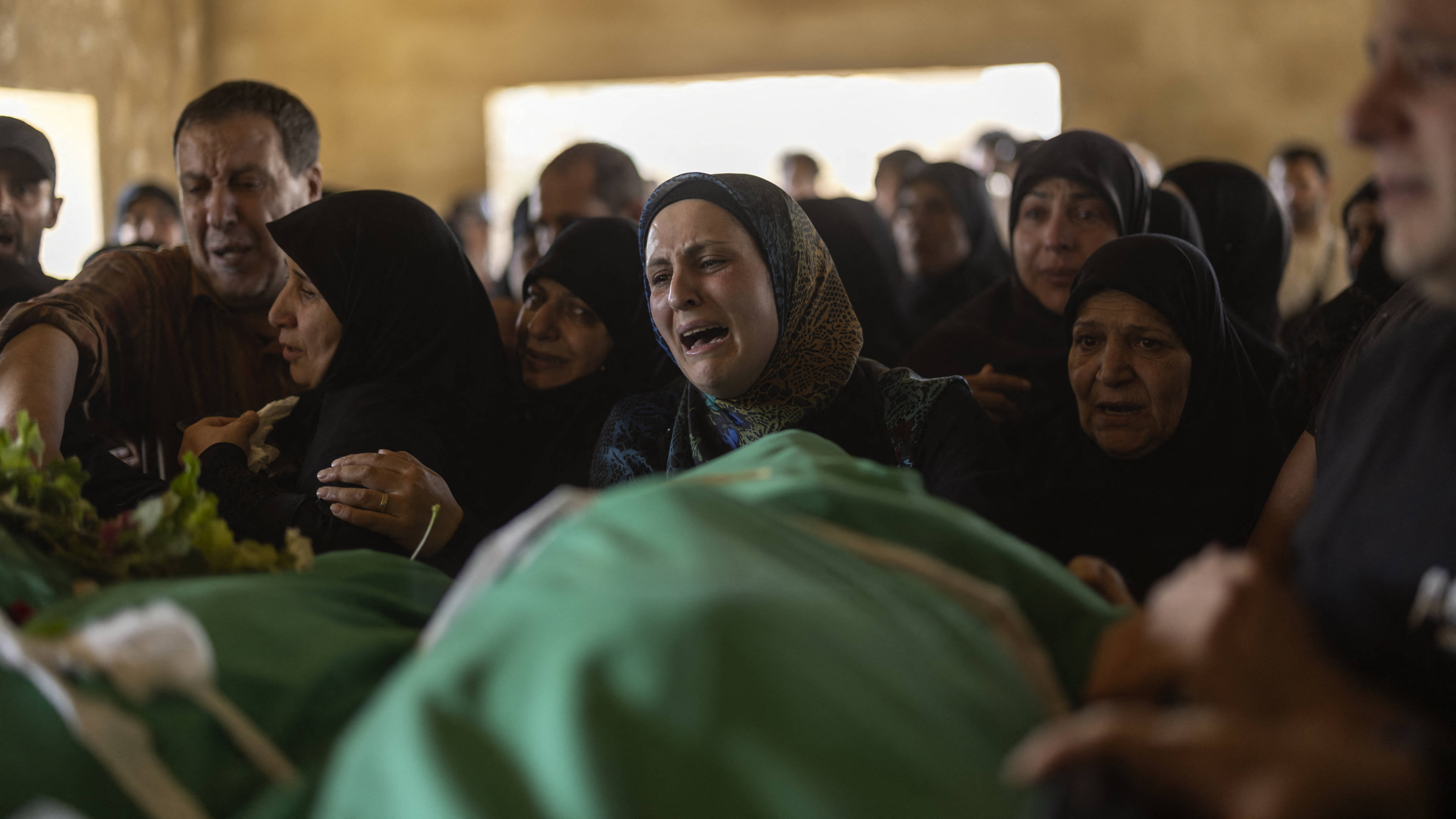 Lebanese mourn during the funeral ceremony of five civilians who lost their lives in an Israeli airstrike in the town of Khodor, in Lebanon's Bekaa Valley, on 9 October 2024 (Fabio Bucciar/AFP)