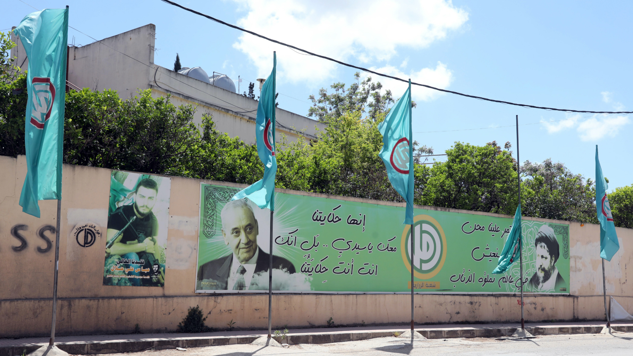 Pictures of Nabih Berri line a wall in southern Lebanon (MEE/Hassan Shaaban)