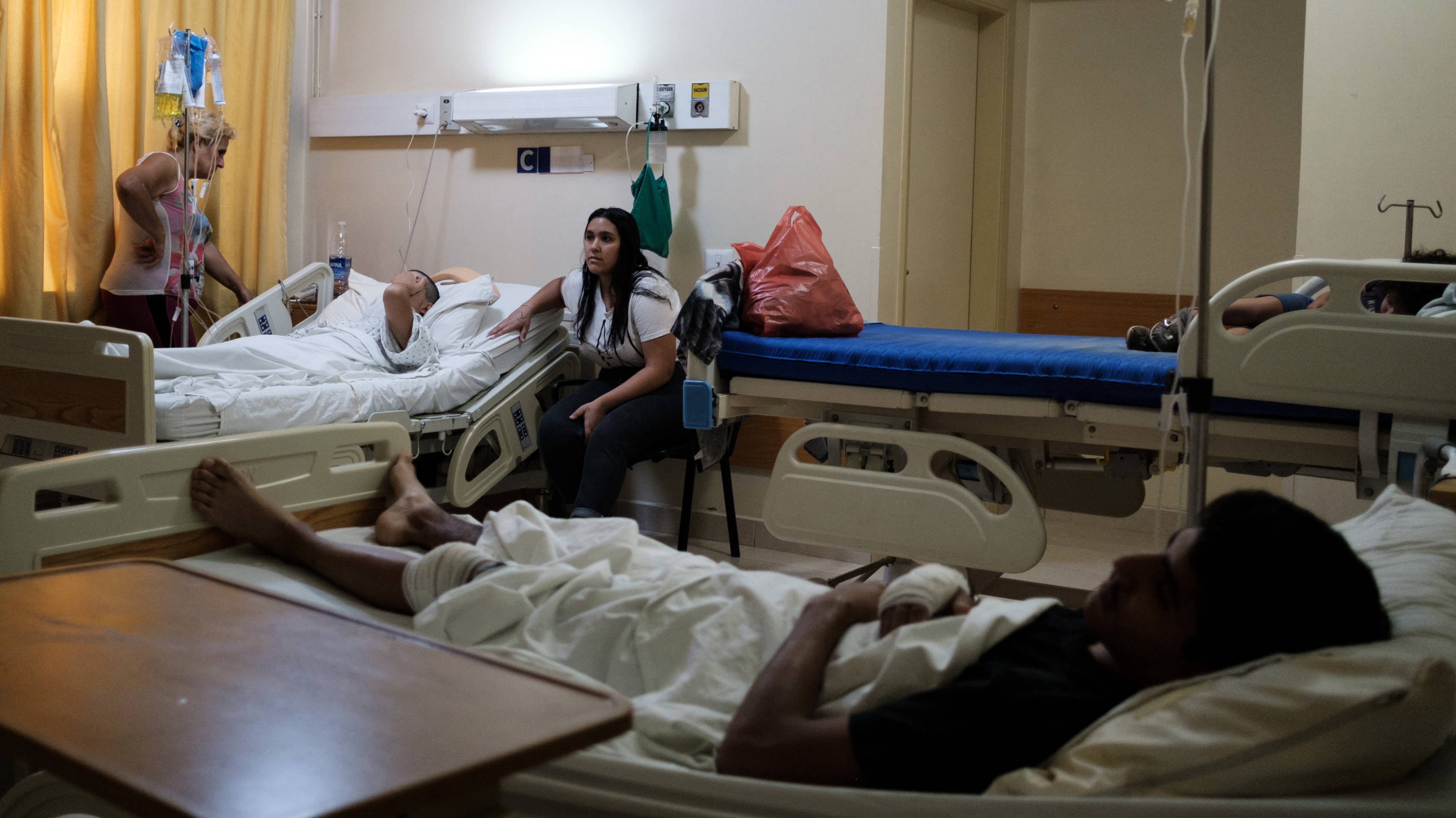 Giovanni and Patrick, two brothers wounded by an israeli strike, lie in bed at the Abdallah Hospital, Riyak city, Lebanon, 7 October 2024 (MEE/Alexandra Henry)