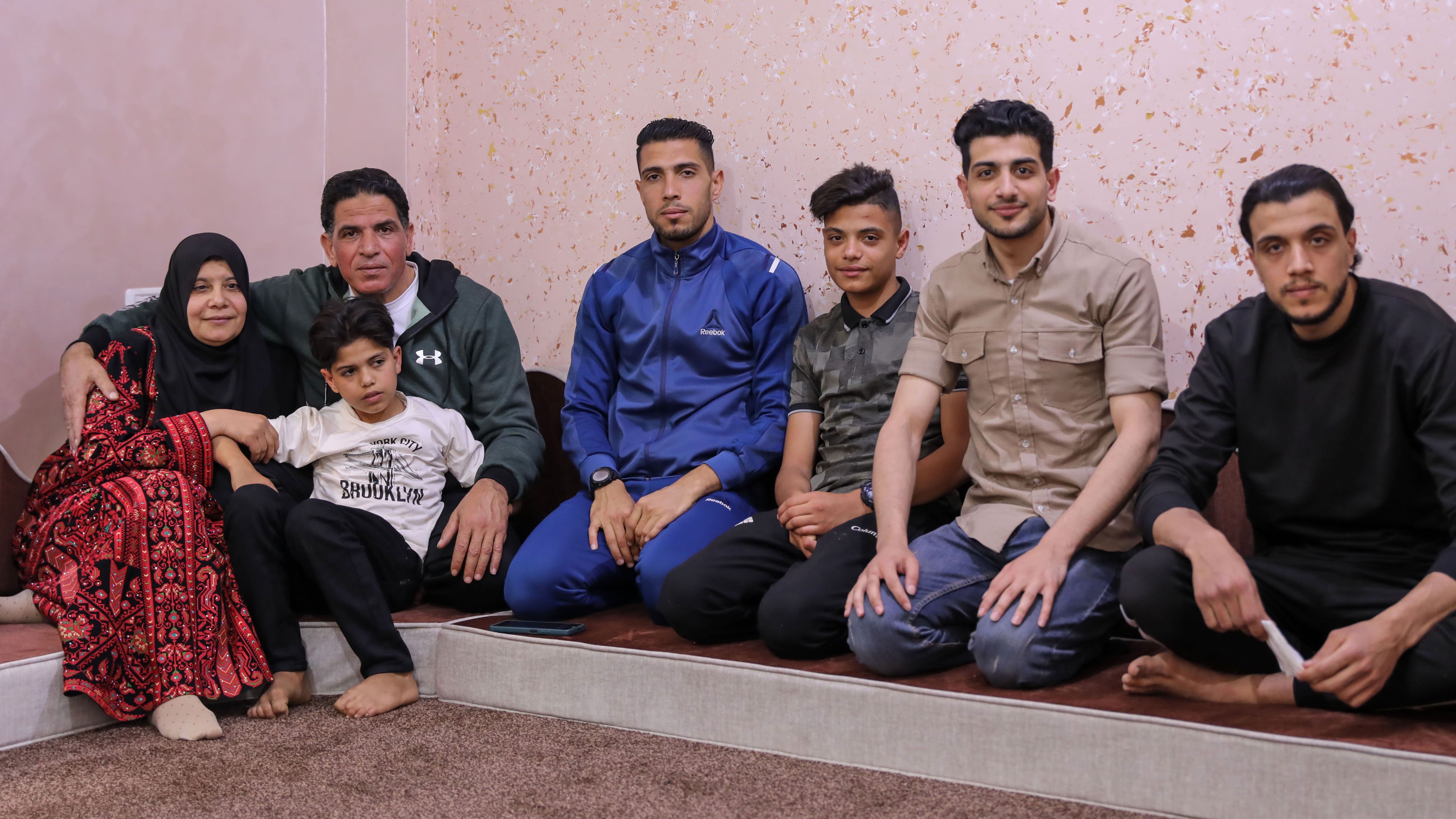 Khaldiya Abumustafa (L) sat next to her husband in their home in the Gaza Strip on 23 April 2023 following his release from Israeli jail (MEE/Mohammed al-Hajjar)