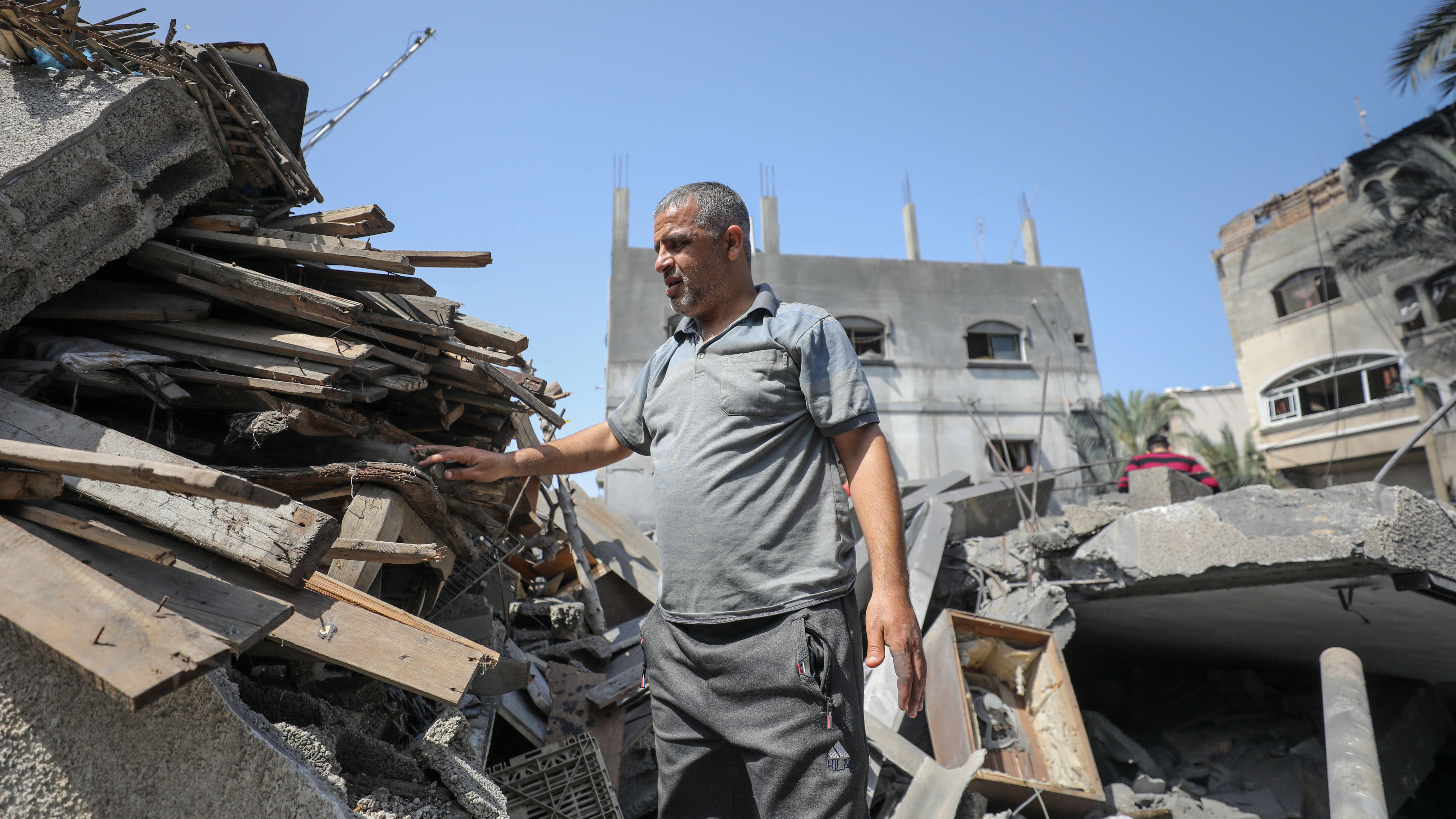 Mohammad al-Masri inspects the damage after his house was flattened by an Israeli strike on 10 May 2023 (MEE/Mohammed al-Hajjar)