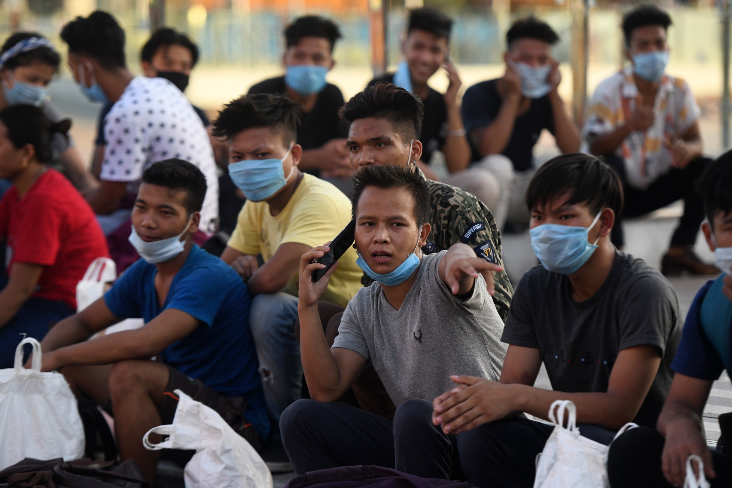 Stranded labourers await to board a special train back to Manipur from the southern city of Chennai on 10 May after the government eased a nationwide coronavirus lockdown (AFP)