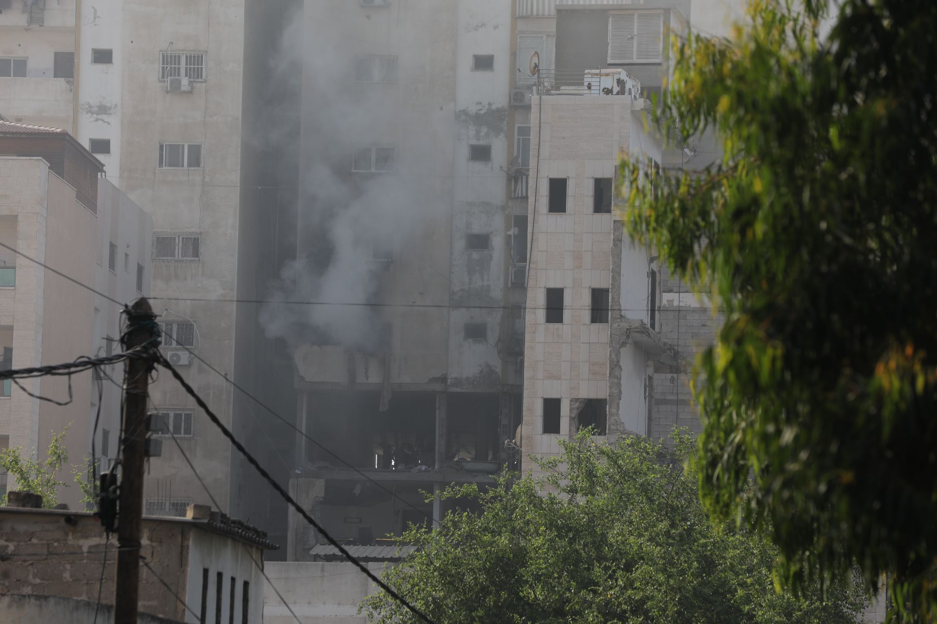 Smoke rises from a building in Gaza hit by an Israeli strike.