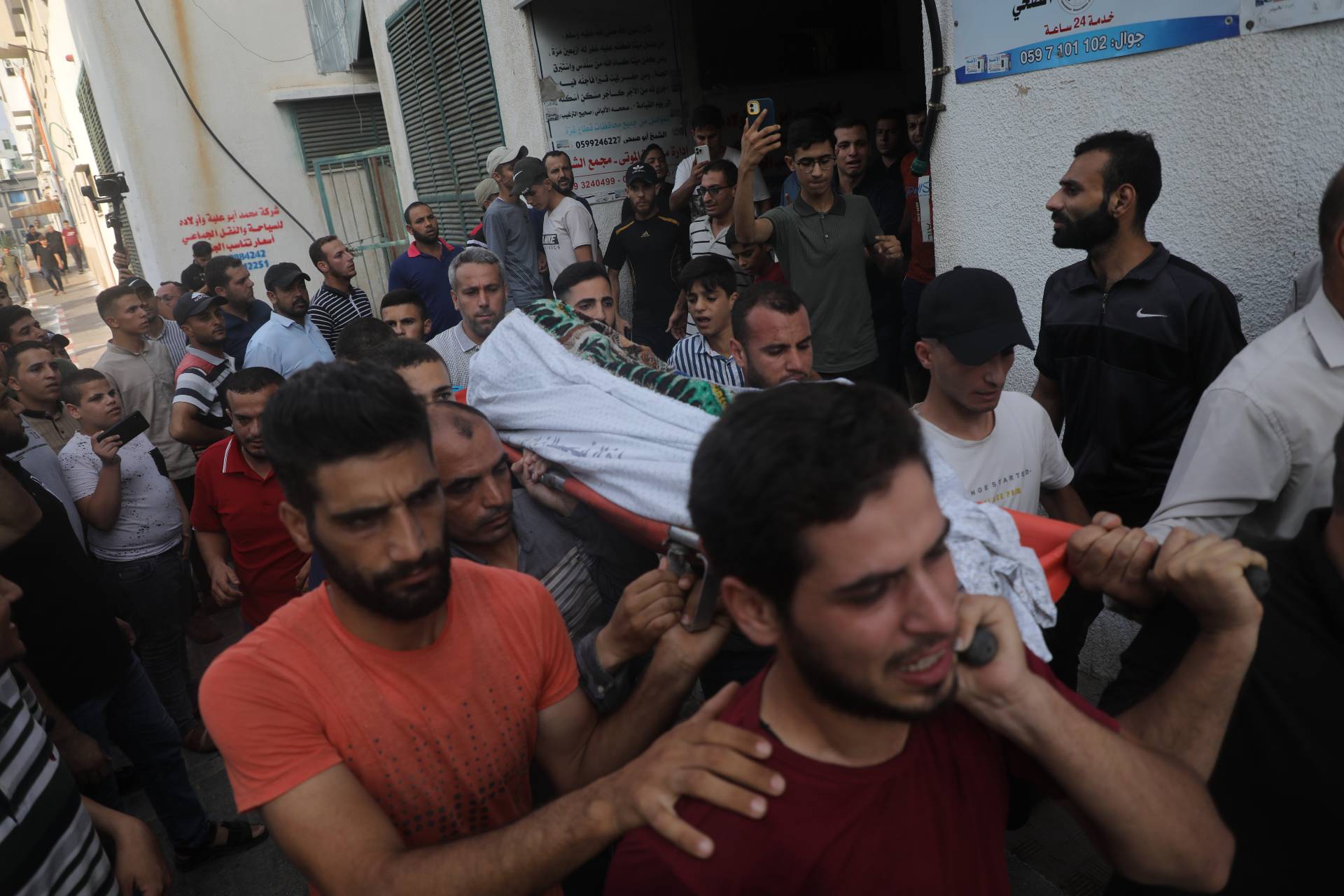 Palestinians in Gaza carry the body of one of the people killed in an Israeli air strike on Friday.