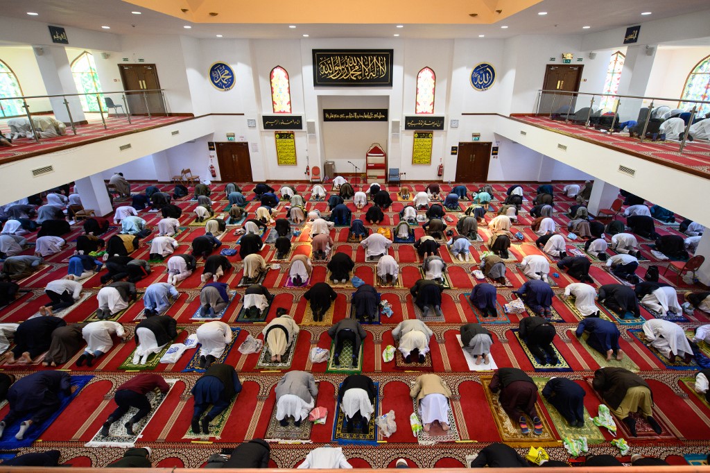 Muslims gather to perform the Eid al-Fitr prayer, which marks the end of the holy month of Ramadan, at Bradford Central Mosque in Bradford, northern England, 13 May 2021 (AFP)