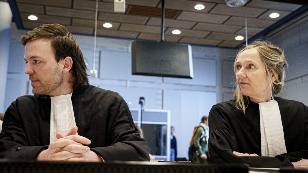 Lawyers Thomas van der Sommen and Liesbeth Zegveld, representing Dutch NGOs, ahead of verdict on the export of parts for F-35 fighter jet in The Hague in February (AFP)