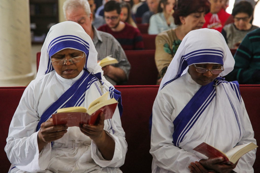 Nuns pray among Palestinian Christians celebrating Easter Sunday Mass at the Catholic Holy Family Church in Gaza City, on March 31, 2024 (AFP)