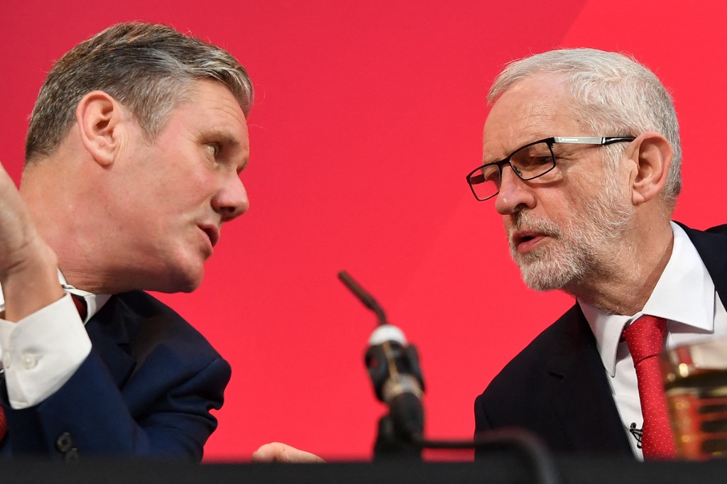 Jeremy Corbyn (R), then Labour party leader, speaks with Keir Starmer, then shadow Brexit secretary, during a press conference in London on 6 December 2019 (AFP)