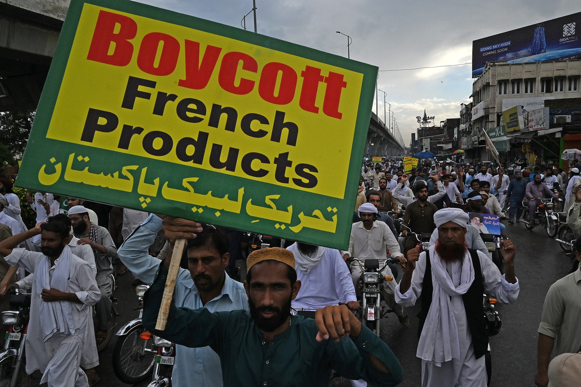 Pakistani demonstrators carry placards during a protest against the reprinting of a cartoon of Prophet Muhammad by French magazine Charlie Hebdo in Rawalpindi on 4 September 2020 (AFP)