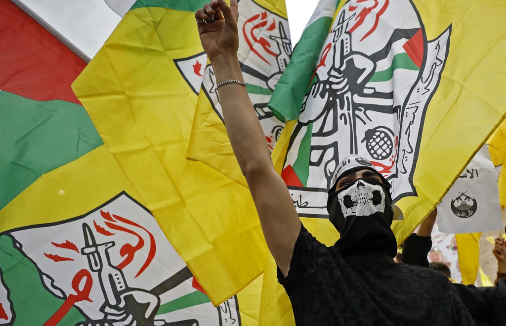Palestinian Fatah supporters at a rally commemorating the 18th anniversary of late Palestinian leader Yasser Arafat's death in the West Bank city of Nablus, 14 November 2022 (AFP)